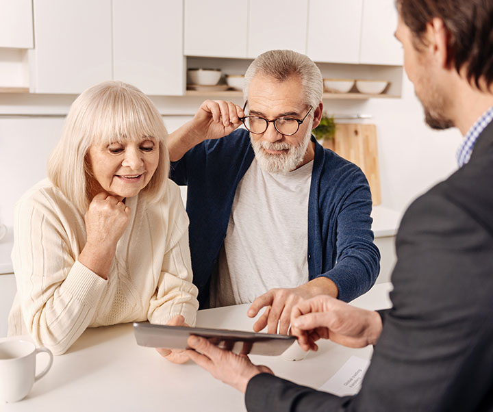 Mature couple getting expert help from real estate agent
