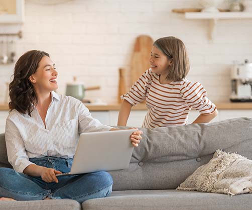 mother and children in sofa with laptop